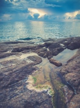 Beautiful seascape. Sea and rock at the sunset (Vintage filter effect used)