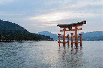 The stunning sunset view  of famous floating torii gate of the Itsukushima Shrine in Miyajima, Hiroshima, Japan