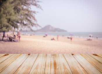 Empty wooden table top with blurred tropical sea beach, can be used for montage or display your products