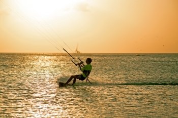 Kite surfer on Aruba island in the Caribbean at sunset
