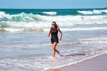 Mature healthty woman running at the beach