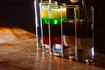 Colorful alcohol  shot drinks on bar. cocktail