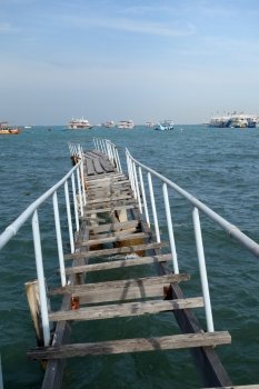 The wooden bridge extending into the sea in Pattaya, Thailand