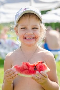 Funny cheerful girl eating watermelon, close-up portrait