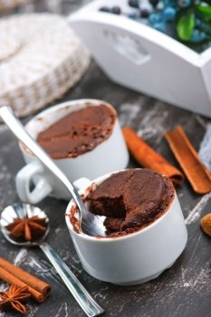 chocolate cupcake in cup and on a table