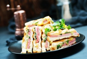 club sandwiches on plate and on a table