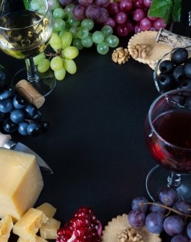 Wine and snacks arranged in the form of a border on a black background