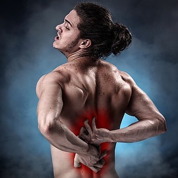 Handsome young man with lower back pain colored in red
