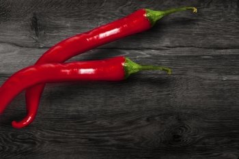 Red chili pepper isolated on wooden background. With clipping path