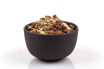 Healthy oat granola muesli cereals with chocolate in a scoop and bowl on white