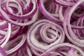 Fresh raw red onion rings full frame close up