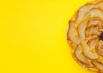 Tarte Tatin apple and pear tart pie isolated on yellow background with copy space