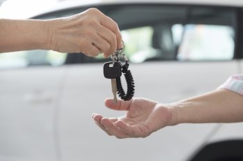 people's hand give and get car key with white car background