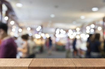 wooden table for display or montage your product with blur background of people in department store for use as shopping concept