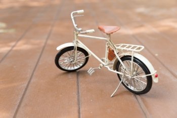 bicycle model on wood floor - travel and journey concept
