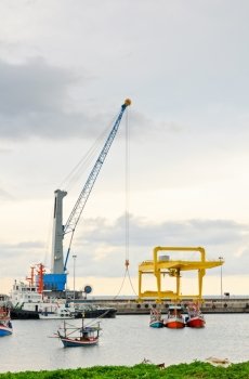Crane for lifting a load up and down the ship in deep water harbor area of Thailand