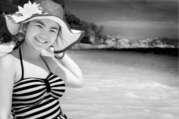 Black and white photograph for background, tourist girl in swimsuit standing with happiness on the beach and sea at Koh Miang Island, Mu Ko Similan National Park, Phang Nga province, Thailand