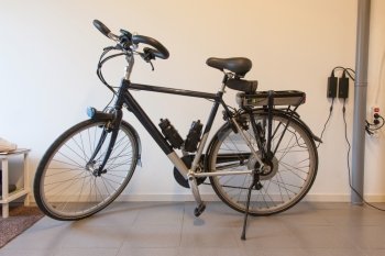 Electric bicycle in a garage, charging the battery