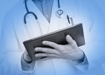 Doctor using a digital tablet, selective focus on tablet, medical blue