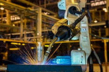 Industrial robot is welding in car factory