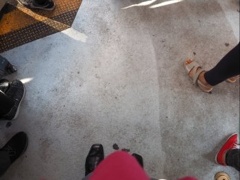Floor with feet. View of concrete floor with feet and copy space in the centre