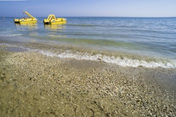 Yellow lifeboat on the beach. Italian beach