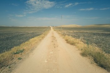 Vintage dirt road and blue sky