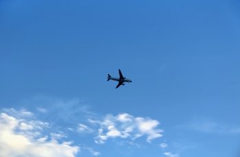 Airplane in the blue sky with white clouds