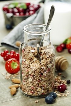Close up of jar with granola or muesli on table - Healthy eating, Detox or Diet concept