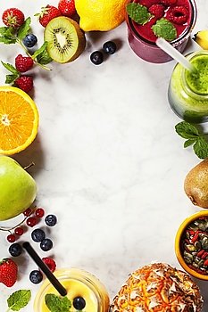 Fresh smoothies and fruits on marble table