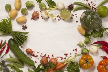 Frame of organic vegetables on white. Top view