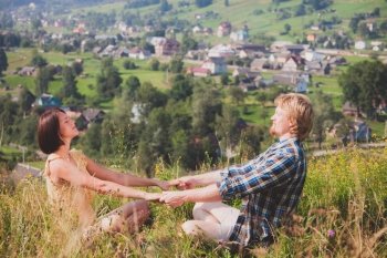 Happy beautiful couple in love over countryside view
