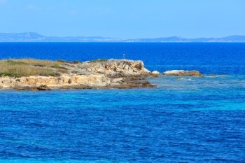 Aegean sea coast with bird on cross, view near Karidi beach (Chalkidiki, Greece).