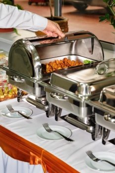 chafing dishes at table ready for wedding catering. catering wedding