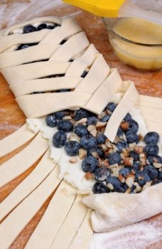 Pie stuffed with cheese cream , blueberry, crushed peanuts braided plait