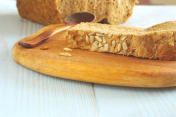 Bread slice organic natural homemade wholegrain healthy nutrition. Healthy dieting food ingredient. Selective focus crust piece. Rustical bread oldstyle eating. Tasty baker meal closeup.