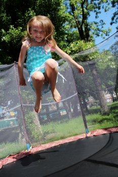 girl jumps on the trampoline. girl jumps on the trampoline in the attraction