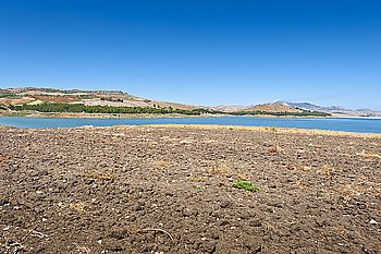Plowed Shore of the Lake Lago di Ogliastro on the Background of the Mount Etna in Sicily 