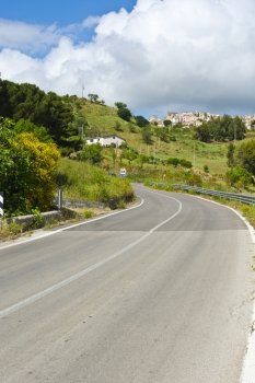 Asphalt Road Leading to the City on the Hills in Sicily