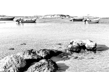 Small motor boats at the beach.  Fishing Boats moored in the mediterranean sea in Israel. Black and White Picture