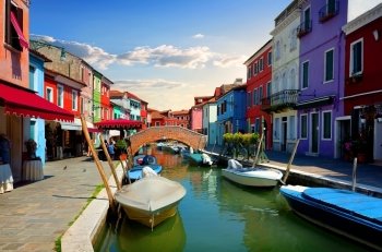 Bright colorful houses and water street in Burano, Italy