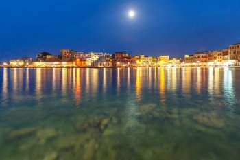 Picturesque view of Venetian quay of Chania with Kucuk Hasan Pasha Mosque at moonlit night, Crete, Greece