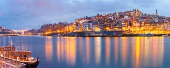 Old town of Porto during blue hour, Portugal.. Ribeira and Old town of Porto with mirror reflections in the Douro River during evening blue hour, Portugal, Portugal.