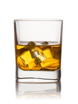 whiskey. Glass of scotch whiskey and ice on a white background