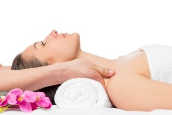 massage the shoulders of a young beautiful woman in spa salon