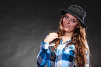 Portrait of pretty gorgeous woman. Attractive young girl with long hair wearing hat and checked shirt. Country style fashion.