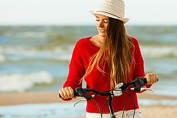 Fashionable girl with bike outdoor.. Young active girl with bicycle on seaside. Smiling cute woman resting near to sea in summer. Fashionable tourist on fresh air.