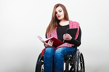 Disabled student with tablet ebook.. College university and job concept. Mobile technology. Young student worker woman with tablet ebook on wheelchair. Disabled person in real life.
