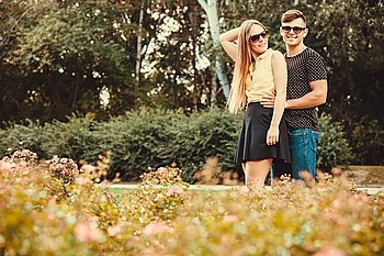 Couple hugging in park. . Love romance relationship dating leisure concept. Couple hugging in park. Young girlfriend with her man together holding hands. 