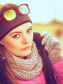 Fitness girl wearing warm sporty clothes in cold day. Sporty woman portrait outdoors. Fitness girl wearing warm sporty clothes in cold day